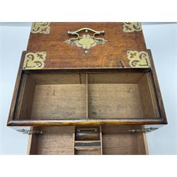Brass mounted oak humidor, the slide action top opening to a base drawer, cedar lined with central compartment and striker, the drawer stamped Rd 107198, H17cm, D18cm