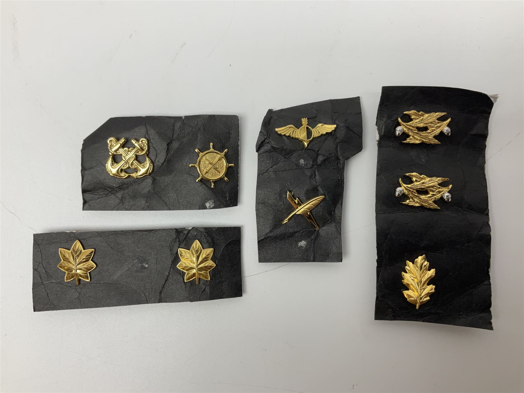 Fifty US rank badges and trade badges; WW2 and Vietnam period; predominantly on sale cards