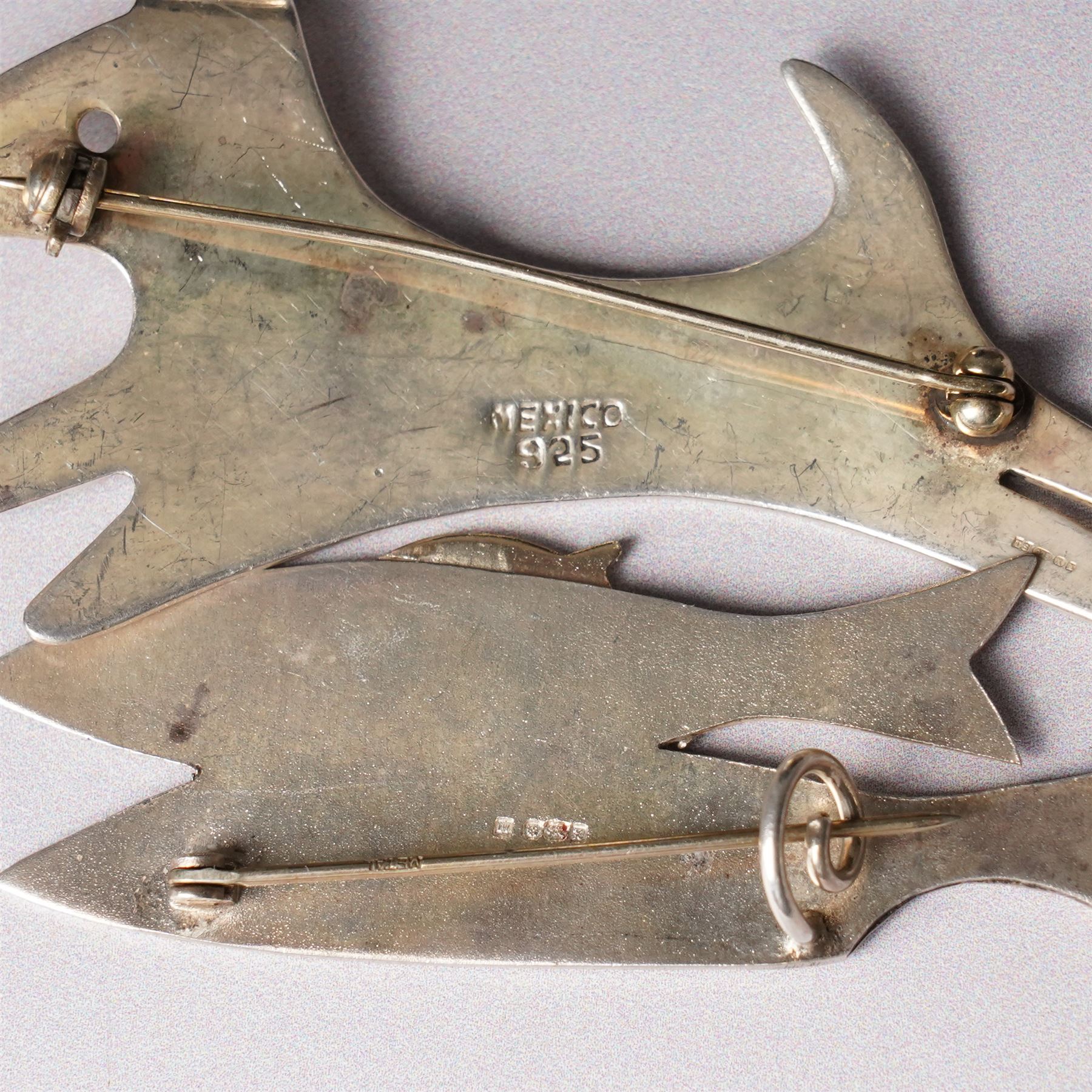Assorted silver including two 19th century condiment spoons, coffee spoon, napkin ring, knife, two silver brooches and a charm 