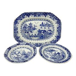 Small late 18th/early 19th century Chinese export blue and white platter, decorated with a central waterside landscape set with fishing vessels, pavilions and two figures upon a bridge, W29cm, together with a pair of similarly decorated octagonal plates, D16cm 