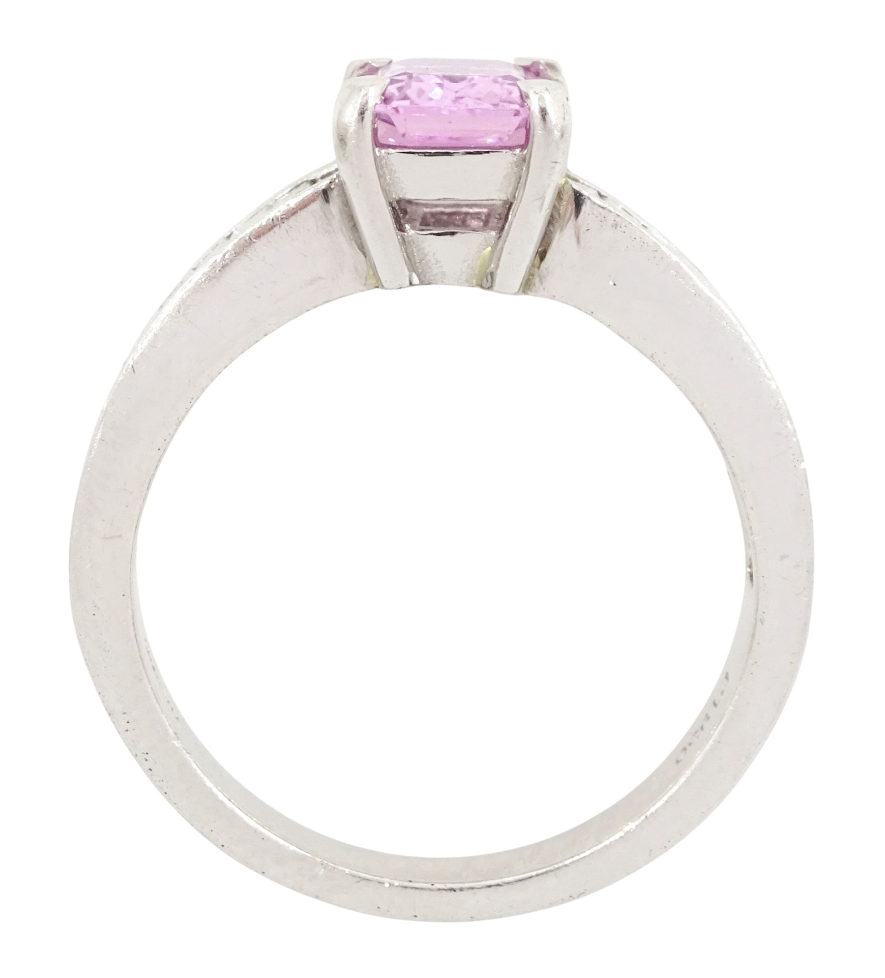 Platinum pink sapphire and diamond ring, single octagonal cut sapphire of approx 1.50 carat, each shoulder set with eleven, channel set baguette cut diamonds, London 2007, total diamond weight approx 1.05 carat