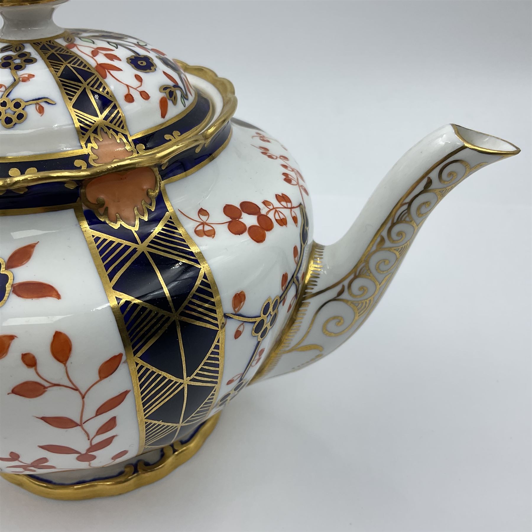 Early 20th century Royal Crown Derby teapot, decorated in a variant of the Imari pattern with blue and red prunus blossoms, with printed mark beneath including illustration date code for 1927, H14cm
