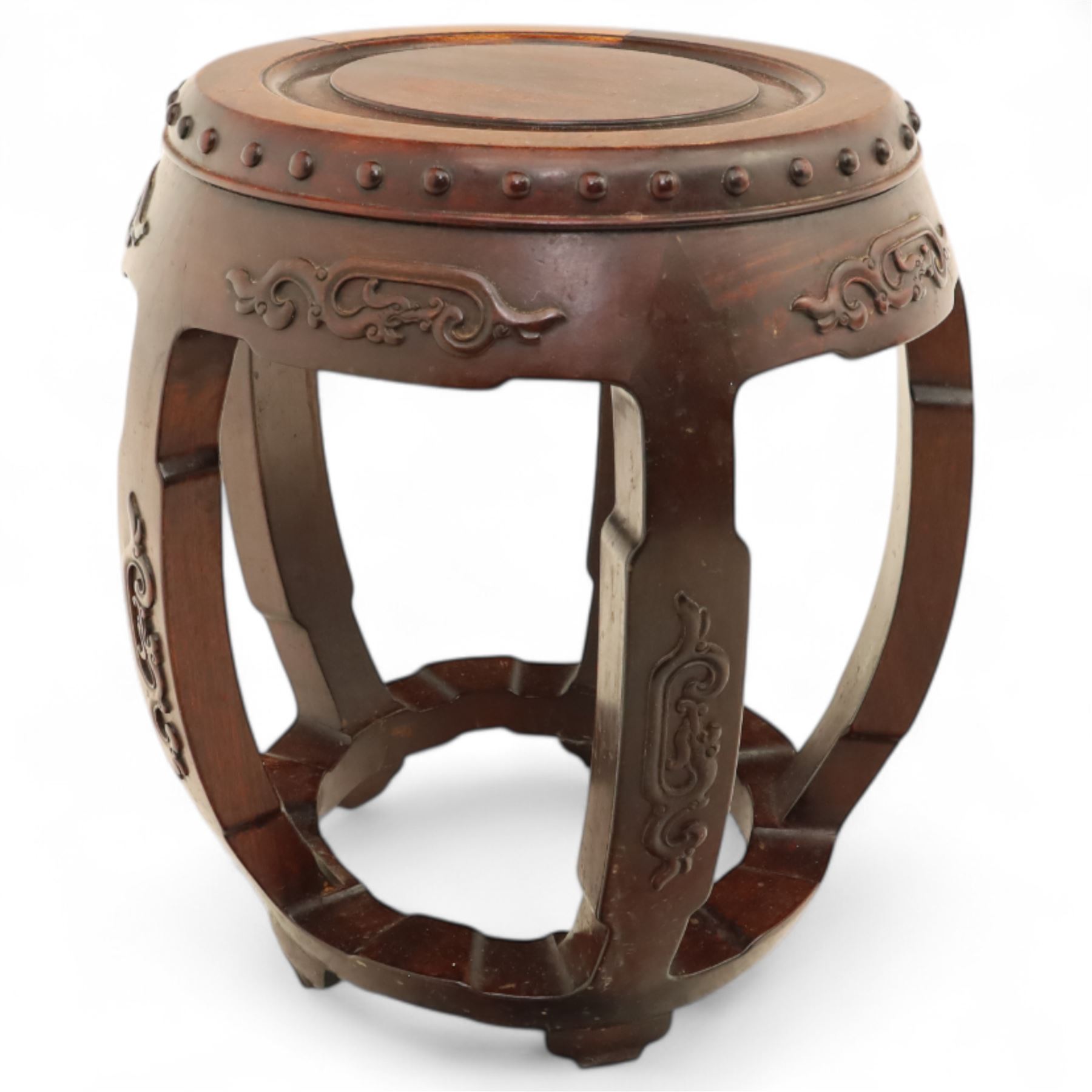 Pair of early 20th century Oriental hardwood barrel seats, of drum form with shaped apron and pierced panels, carved with stylised scrollwork and studded detail to the top
