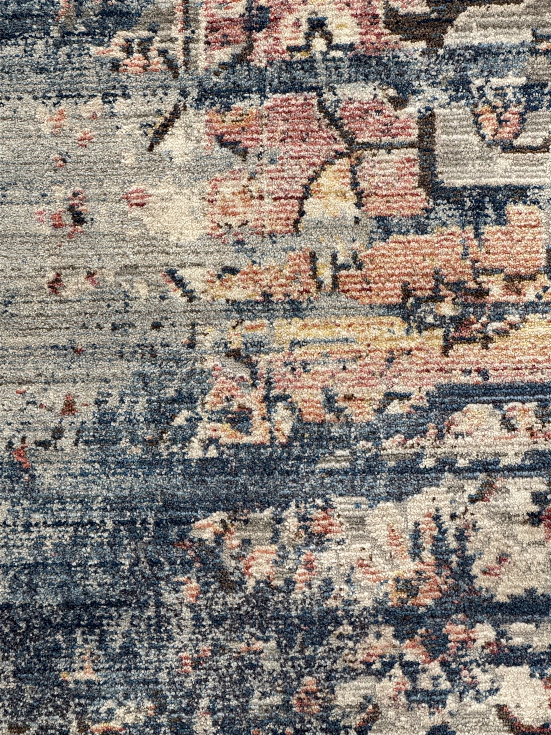 Contemporary Dunelm Soraya Persian design rug, blue and beige ground with faded floral and vine motifs, central medallion and trailing foliate patterns, bordered by a distressed design with stylised floral motifs
