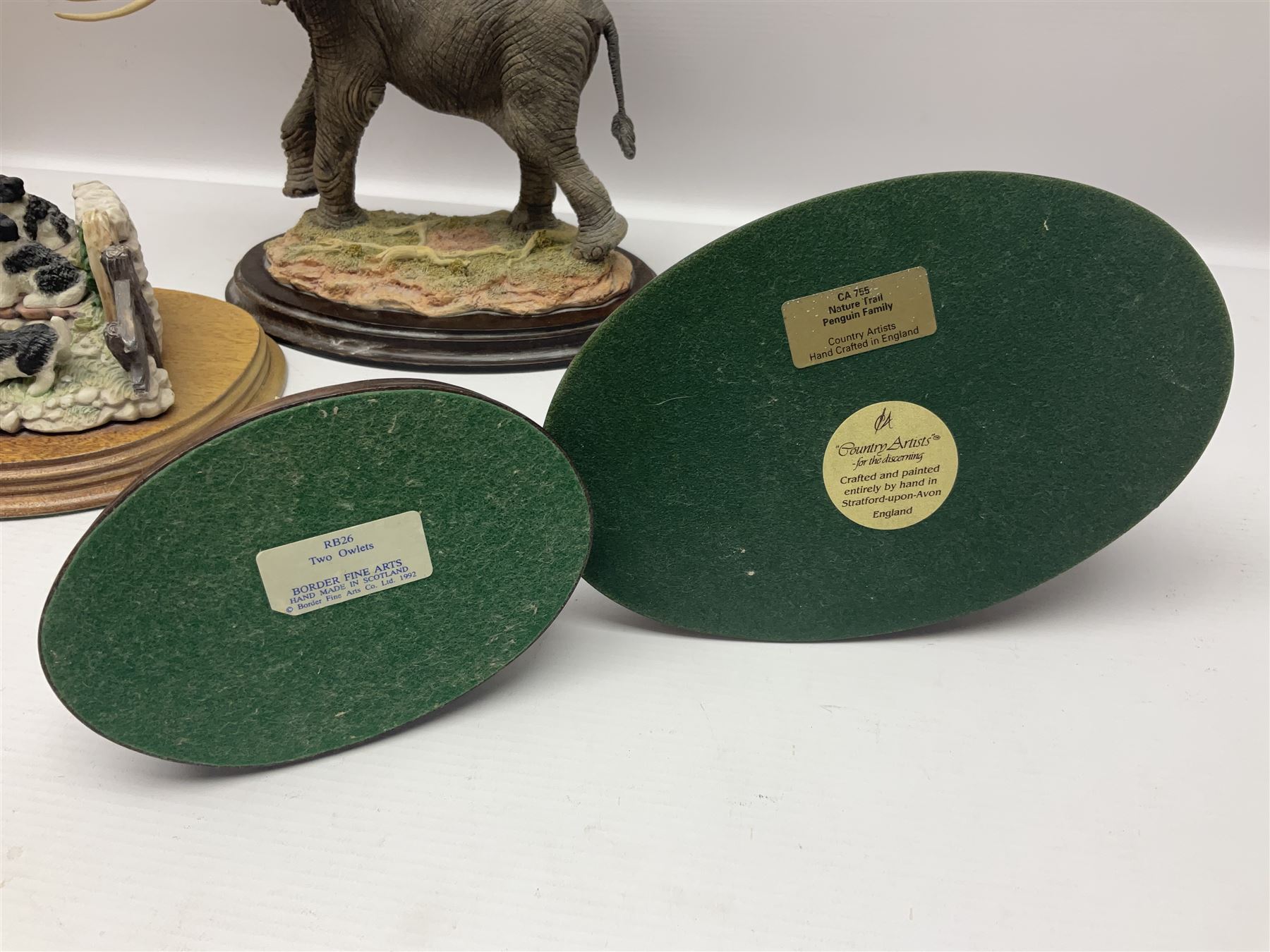 Border Fine Arts figure 'Two Owlets', together with Country Artists figures, 'Bull Elephant' and 'Penguin Family' and a Leonardo Border Collie group figure, tallest H22.5cm