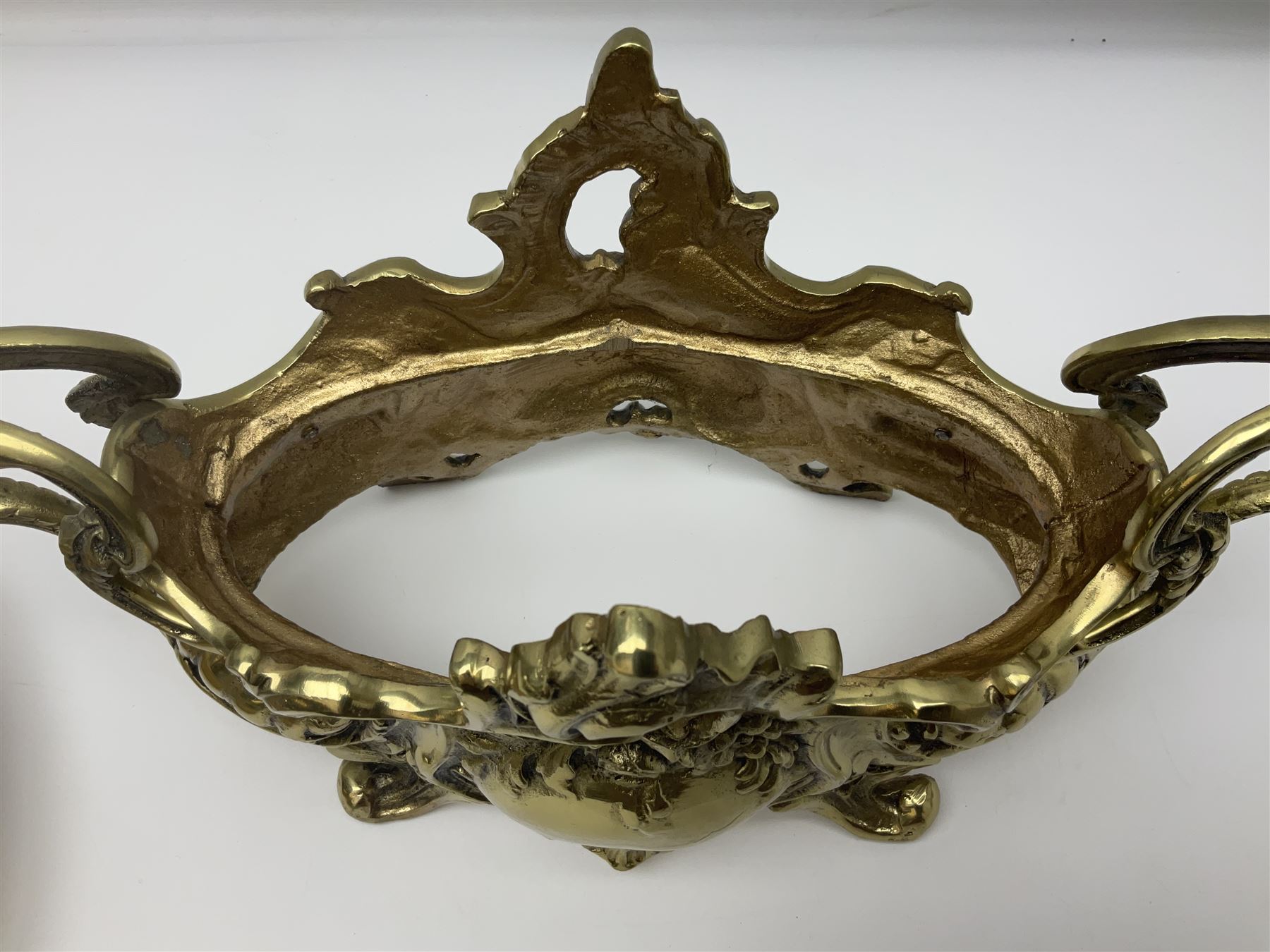 Ornate brass centrepiece, with twin handled vase upon a mirrored base, with floral and scrolling decoration, H23cm 