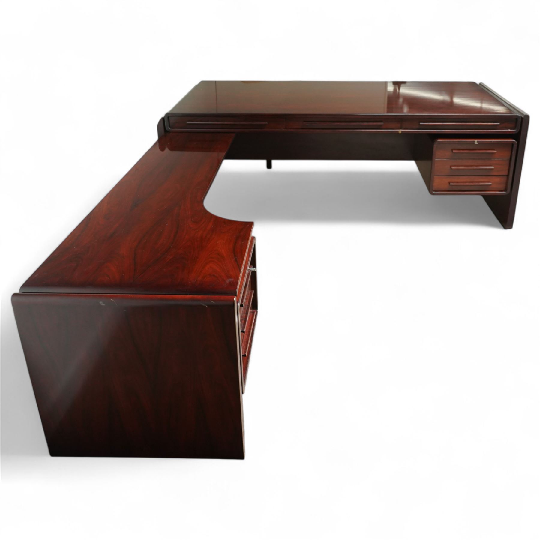 Dyrlund - contemporary Santos rosewood executive desk set, main desk with a rectangular top and leather writing pad above, floating drawer unit with right-angled desk unit top with document tray above a filing drawer 

Note: Dyrlund is a Danish furniture manufacturer known for its high-quality, handcrafted pieces, particularly in the mid-century modern style. Founded in 1960 by Frits Hjerte Dyrlund in Rude, Denmark, the company has remained a family business, now run by the second and third generations. Dyrlund specializes in both home and executive office furniture, focusing on practicality, solid construction, and classic design