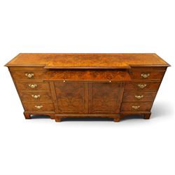 Georgian design figured and burr walnut breakfront sideboard, shaped rectangular top inlaid with crossbanding and stringing, fitted with central brushing slide over cupboard enclosing single adjustable shelf, flanked four graduating cock-beaded drawers to each side, raised on bracket feet