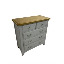 Painted chest with oak top, fitted with two short and three long drawers, raised on square supports with shaped apron, in cream finish
