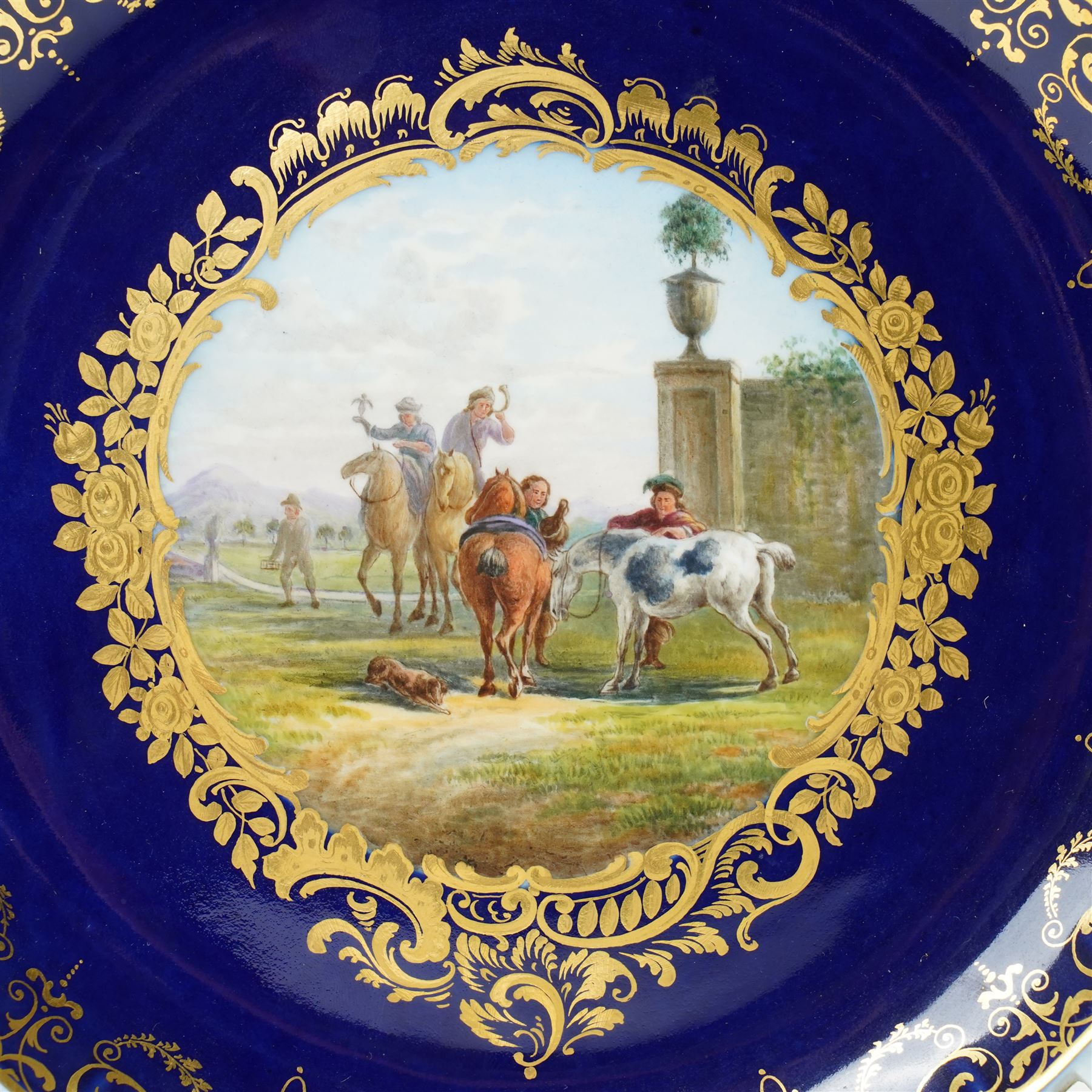 19th century Meissen cabinet plate, the reticulated border modelled with trellis panels and forget-me-nots,  the cobalt blue well with gilt bordered central reserve painted with a scene of a hunting party after Philips Wouwerman (Dutch 1619-1668), underglaze blue crossed swords and indistinct impressed numbers verso, D26cm
