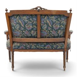 20th century French Louis XVI style stained beech two-seat salon settee, rectangular upholstered back and seat in floral tapestry fabric, carved and moulded frame with foliate cresting, padded open arms and fluted tapering supports