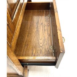 Late 20th century medium oak television/side cabinet, two cupboard doors above single fall front drawer, bracket supports 