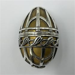 Modern silver limited edition Easter egg, no. 70/500, the gilded body decorated in relief with silver latticework and a band of flower heads, the detachable cover opening to reveal a gilt interior, each hallmarked St James House Company, London 1978, H5.5cm