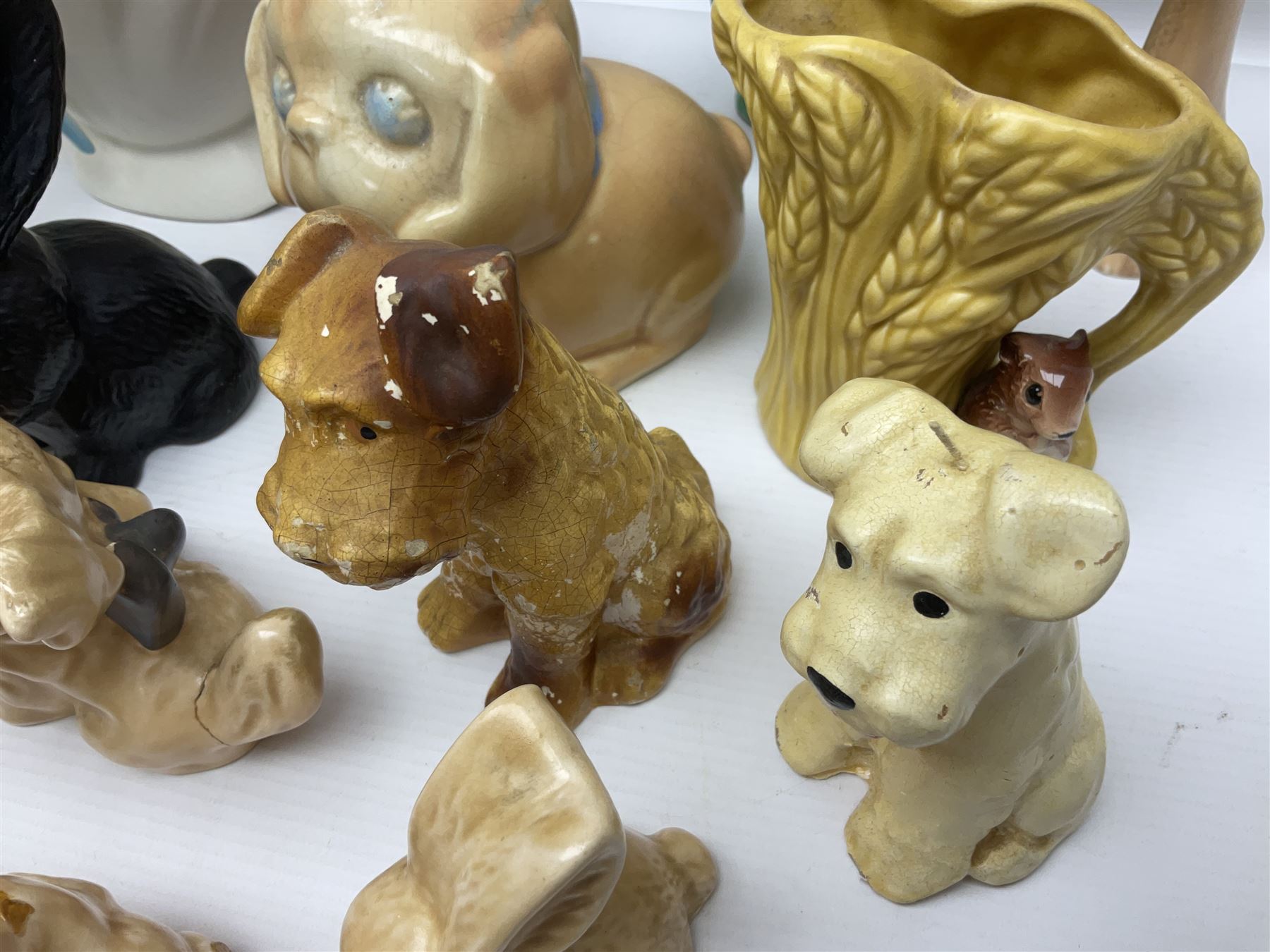 Collection of Sylvac and similar animal figures, including rabbits, hares and dogs, together with Falcon budgie vase, etc 