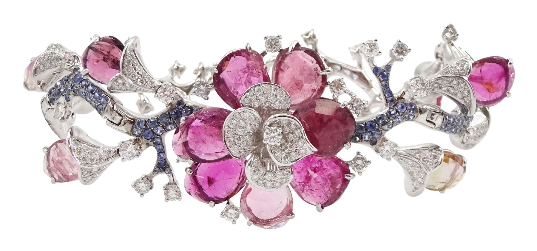18ct white gold gemstone set floral jewellery suite, comprising necklace, pair of earrings and bracelet, each with tourmaline flower petals, round brilliant cut diamond centres and sapphire stems, stamped