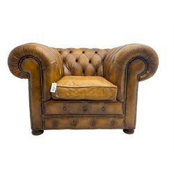 Chesterfield armchair, upholstered in buttoned tan leather with studded detail, on turned feet