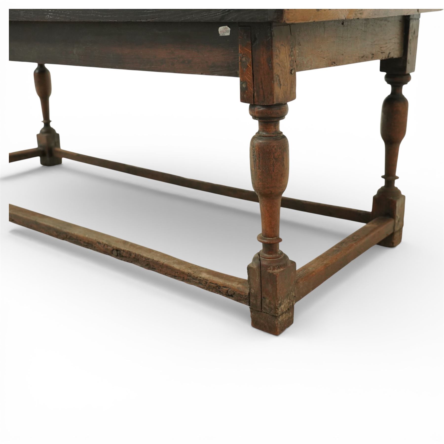 Late 17th to early 18th century oak joint refectory dining table, rectangular four plank top, raised on turned baluster legs, united by chamfered stretchers