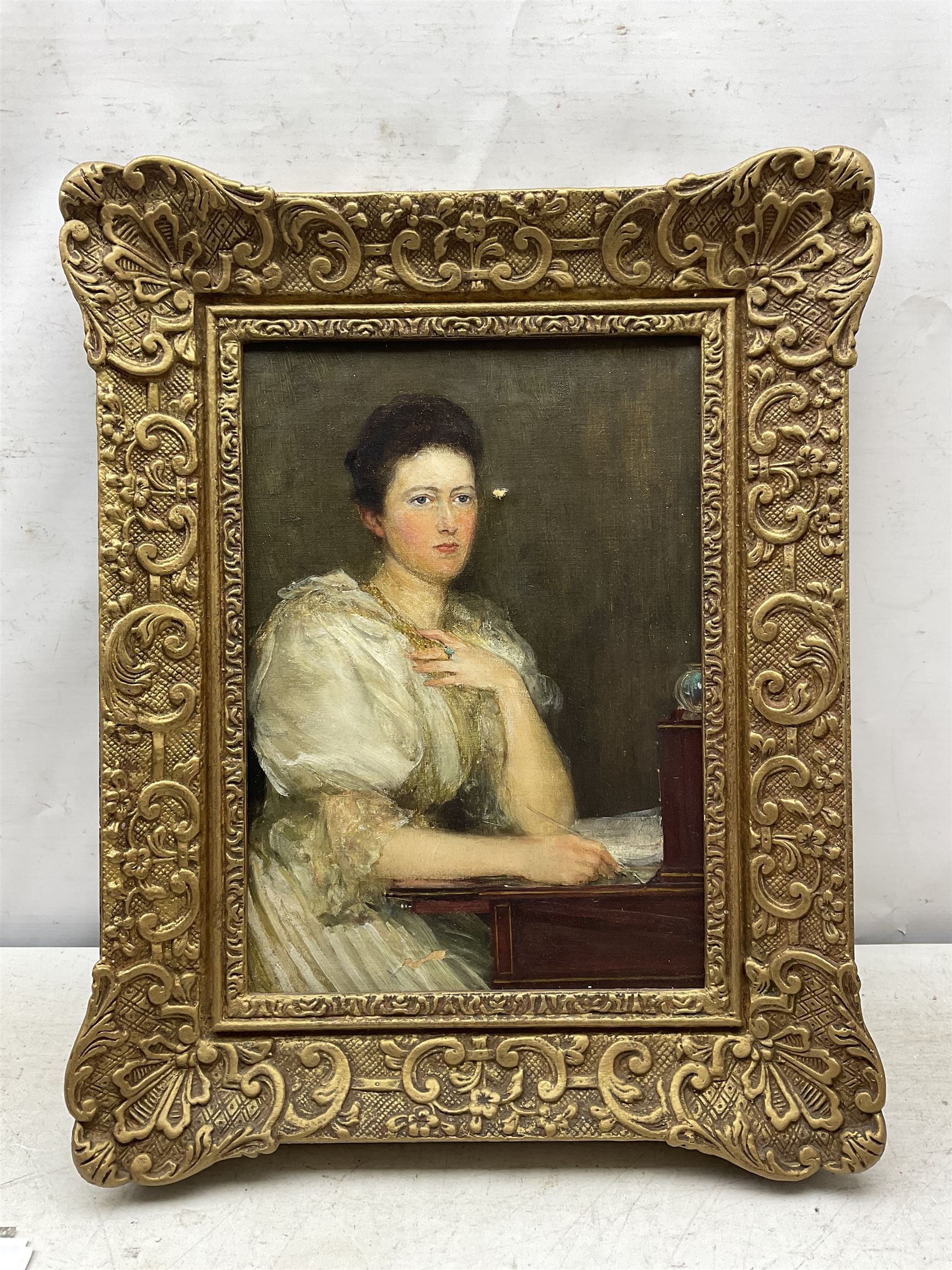Theodore Blake Wirgman (British 1848-1925): Portrait of a Lady in her Study, oil on canvas signed 35cm x 24cm 