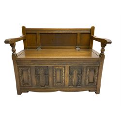 20th century oak monk's bench settle, hinged box seat over panelled front with carved arch decoration