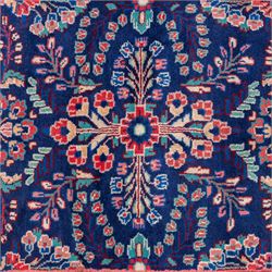 North West Persian runner, the indigo field decorated with repeating symmetrical floral sprays, rosettes and curling foliage in coral, ivory and pale blue tones, enclosed by a red ground trailing flowerhead border and narrow patterned guard bands 