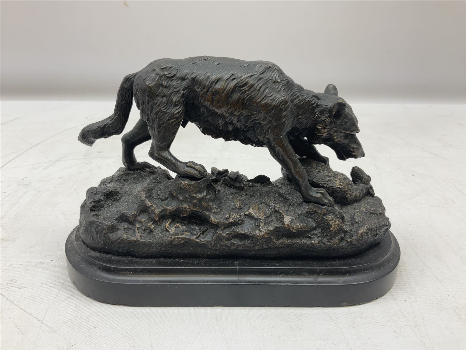 Bronze figure of a wolf with lamb prey, L18cm