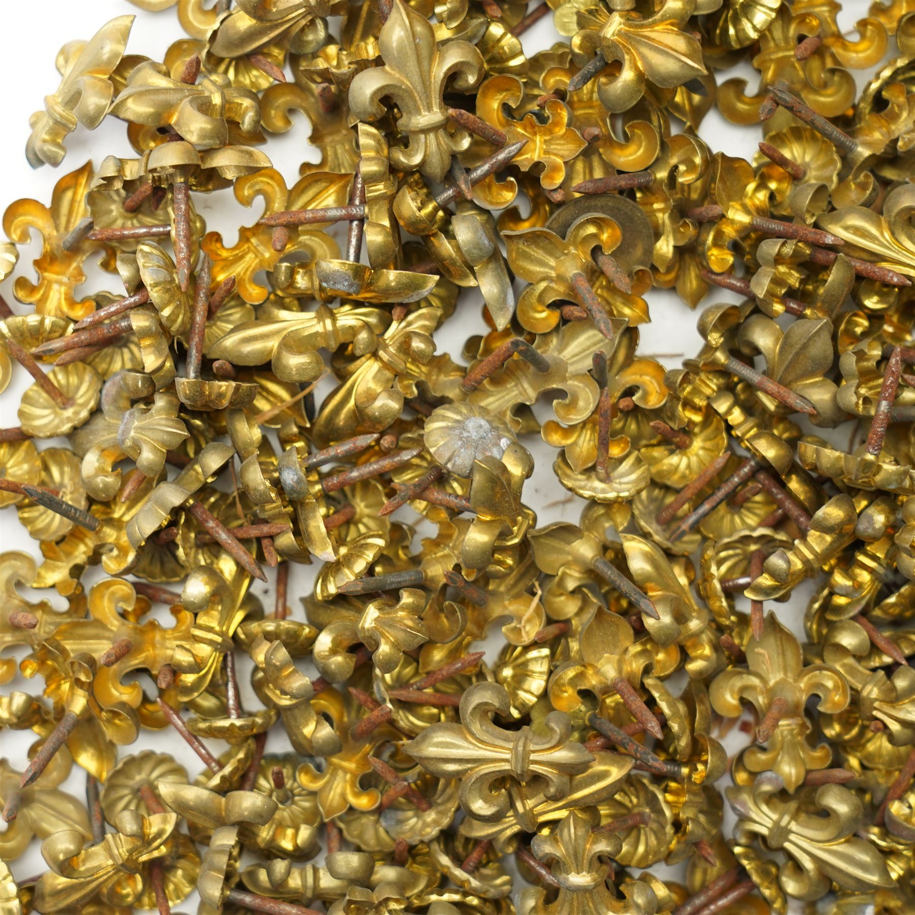 Large quantity of Victorian brass upholstery pins with rosette and fleur de lis designs 
Provenance: property of a Nobleman