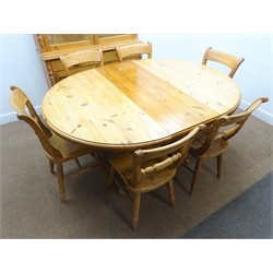  Solid pine circular extending dining table, single column support on four shaped feet (W129cm, H76cm, D170cm) with six chairs and pine dresser, two doors enclosing shelves, two drawers and cupboards, turned supports (W123cm, H193cm, D45cm)  