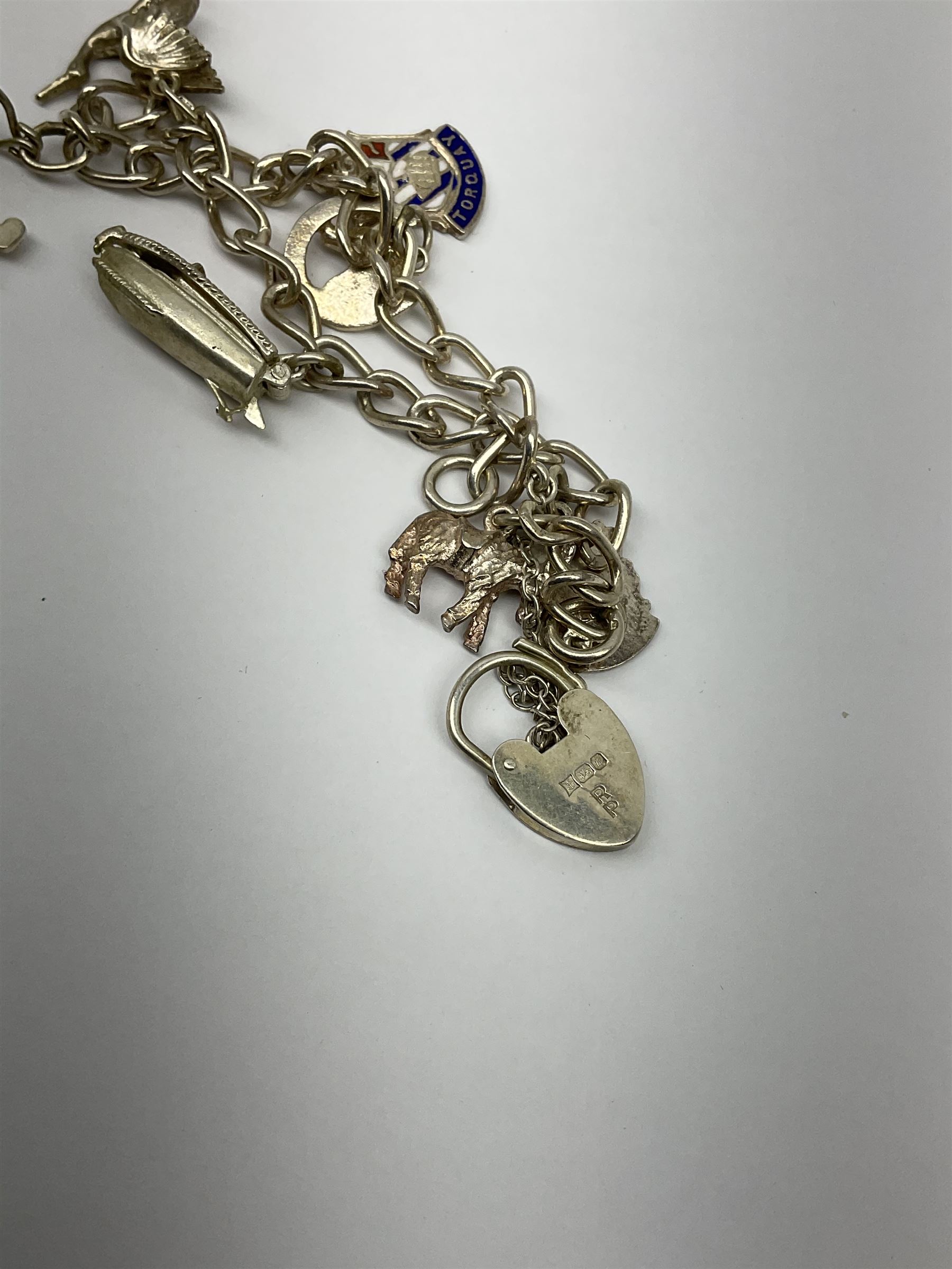 Two Klaus Kobec Entourage gentleman's and ladies, bicolour stainless steel quartz bracelet wristwatches, round white dials with Roman numerals and date apertures, both boxed, silver charm bracelet, silver jewellery and other costume jewellery