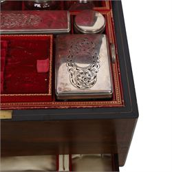  Victorian brass inlaid rosewood dressing table box, retailed by F.L. Hausburg, Liverpool, the lid centred by a brass cartouche, opening to reveal letter store to lid underside, above a fitted interior, with ten mounted cut glass jars, bottles and manicure set, within lift out leather trays, above jewellery drawer, with key, H17cm D24cm