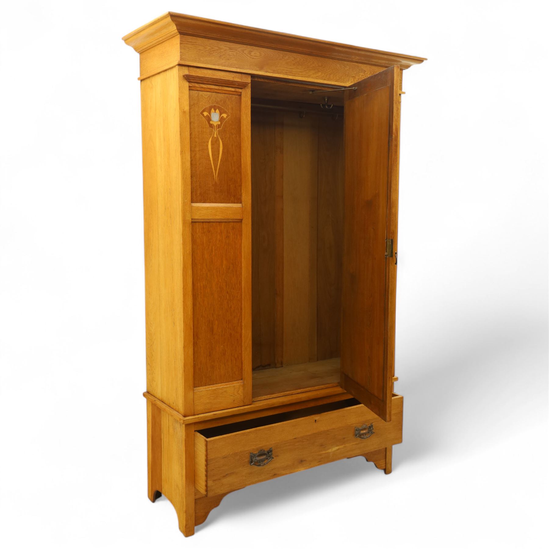 Art Nouveau oak wardrobe, central mirrored door flanked by panels inlaid with stylised tulip motifs, fitted with hanging rail and hooks, single drawer to base with brass handles