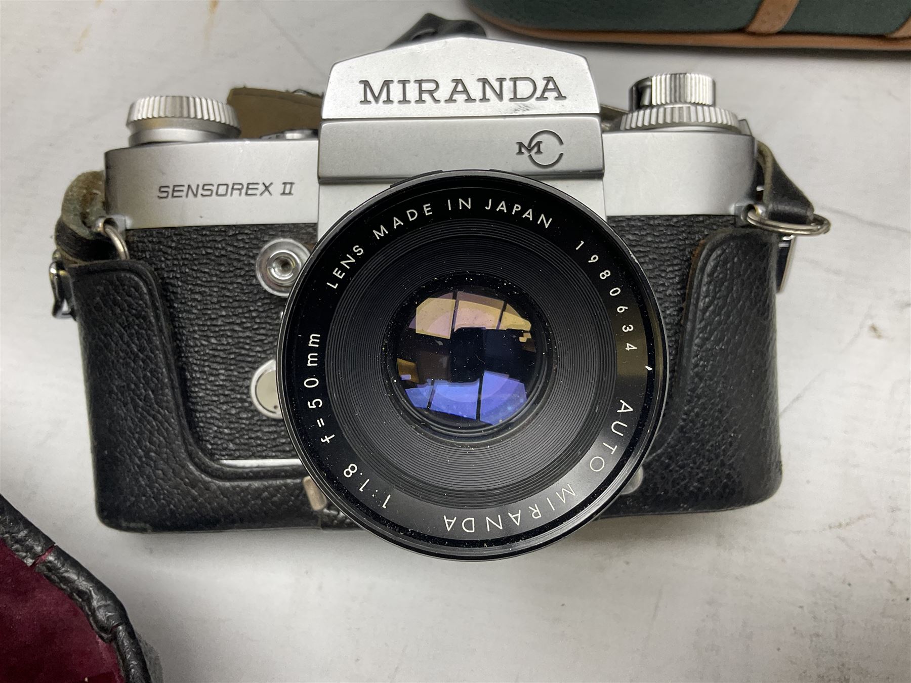 Miranda Sensorex camera body, Miranda Sensorex II camera body with 'Auto Miranda 1:1.8 f-59mm' lens, 'Auto Miranda 1:2.8 f-135mm' lens, 'Auto Miranda 1:3.5 f-200mm' lens, 'Auto Miranda 1:2.8 f-28mm' len, Agfa plate camera with 9cm x 12cm plates and other camera equipment including Miranda camera bag