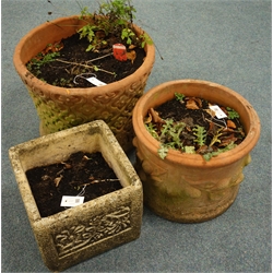  Two circular terracotta planters with floral mouldings, (D51cm, H39cm, largest planter), and single square composite stone planter  