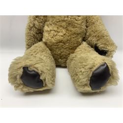 1950s sheepskin plush covered teddy bear with musical movement, the revolving head with applied eyes, leather nose and stitched mouth, jointed limbs with leather pads H50cm