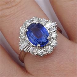 18ct white gold sapphire and diamond cluster ring, the central oval sapphire of approx 2.10 carat, with tapered baguette diamonds and round brilliant cut diamond surround, stamped 750