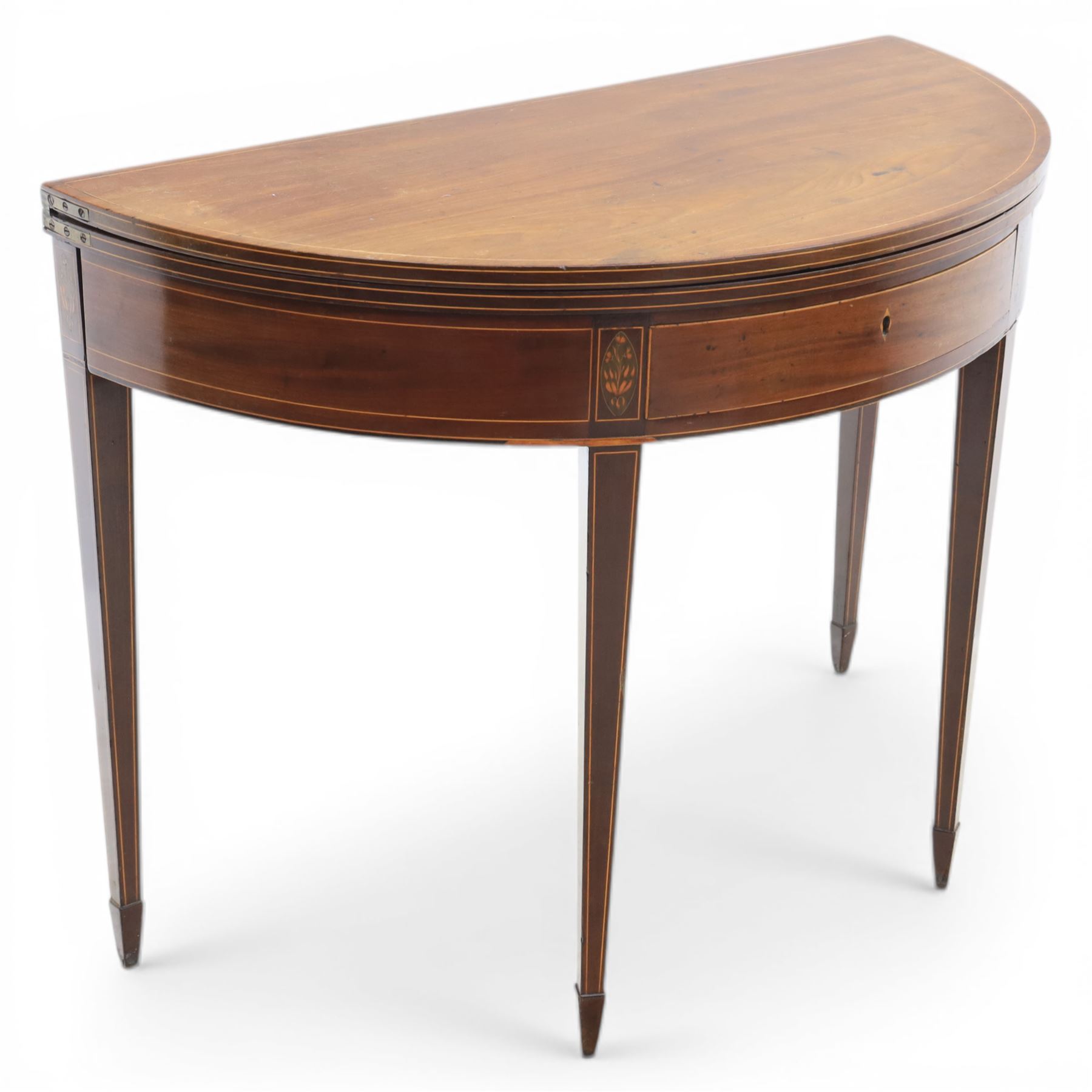 George III Scottish inlaid mahogany demi lune tea table, the curved fold over top opening to reveal a circular top with inlay to edge, above a frieze drawer with key, raised upon tapering inlaid legs with spade feet