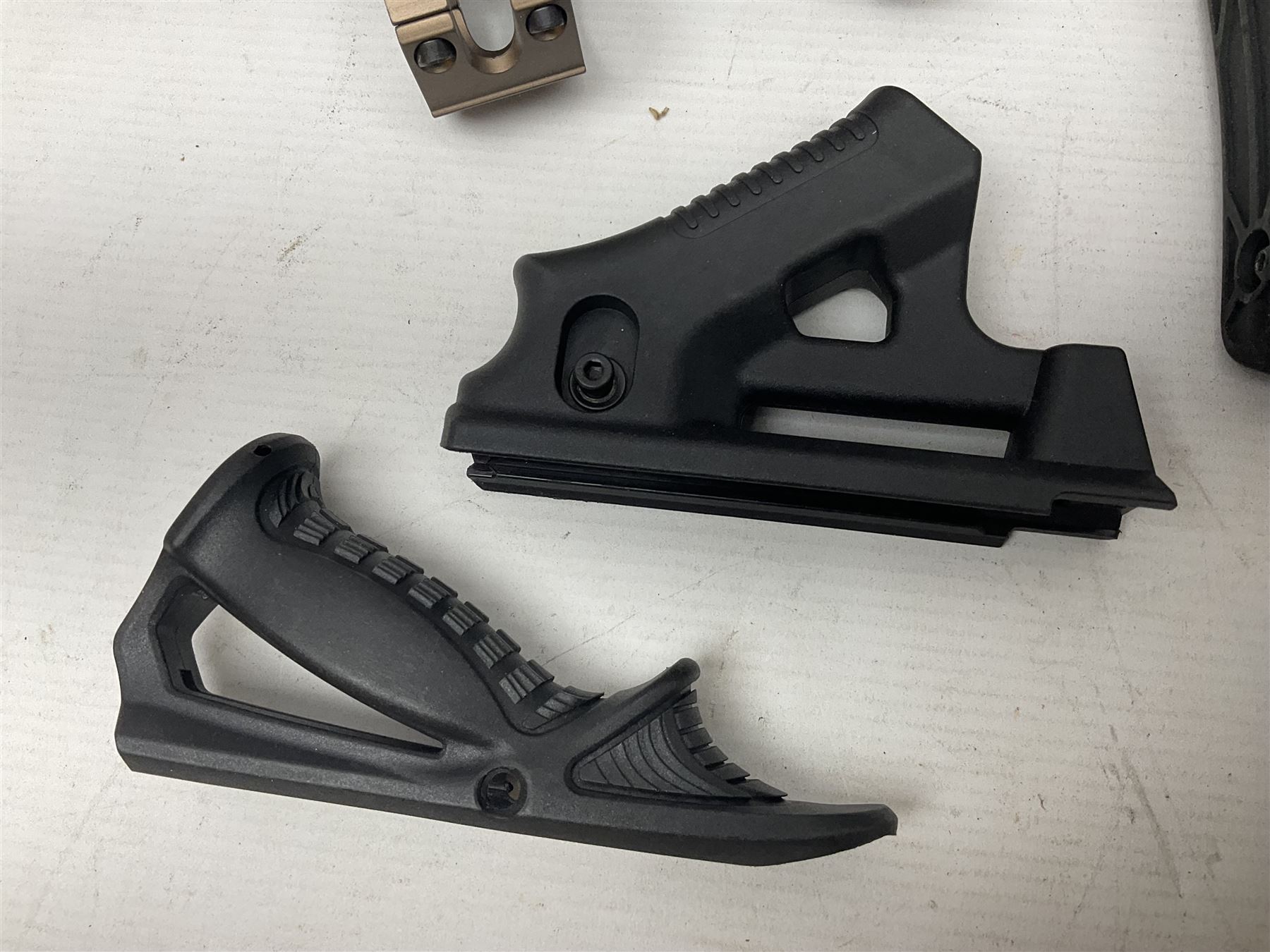 Assorted shooting accessories including two telescopic sights, red dot sight,  two bi-pods, spirit level mount, two gun butts and two forward handles