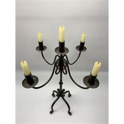 A patinated wrought iron five branch candelabra, on four scroll feet, H60cm 