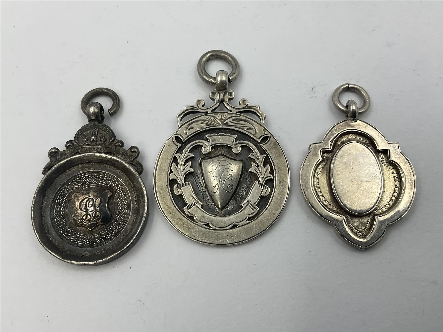 Ten early 20th century silver cartouche fobs, to include a Yorkshire Rose example, all hallmarked with various dates and makers
