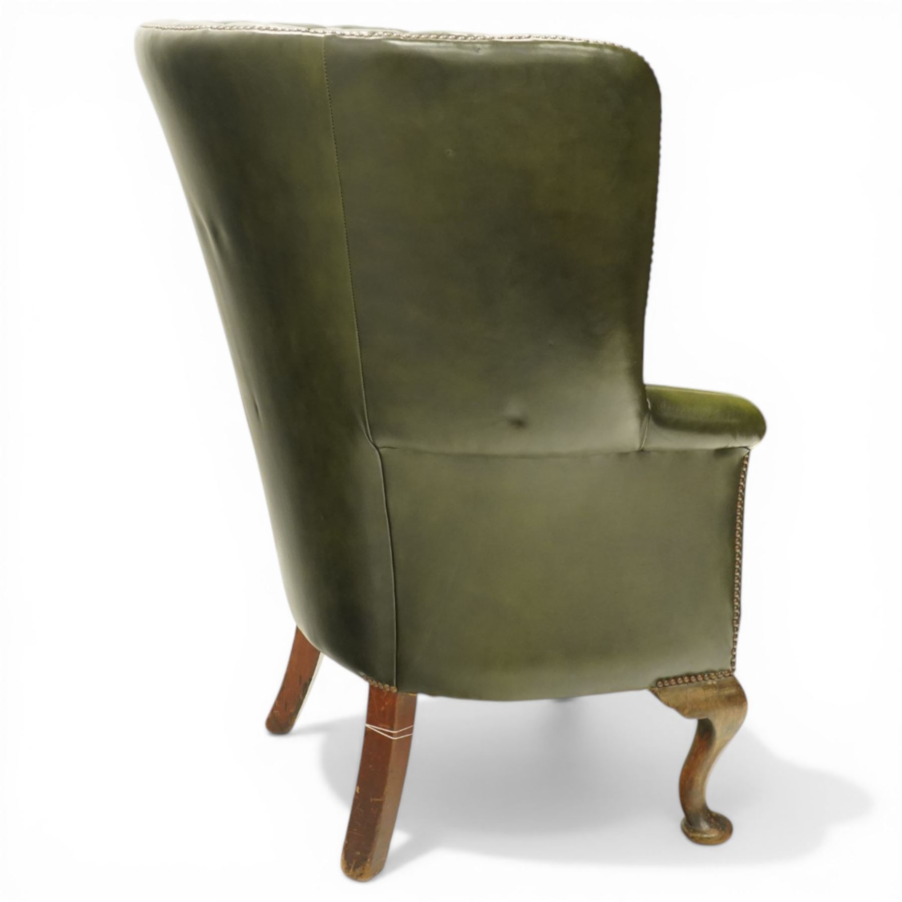 Georgian design green leather barrel-back wingback armchair, pleated upholstered back with shaped wings over scroll arms and sprung-seat, close nailed border, raised on cabriole supports terminating in pad feet
