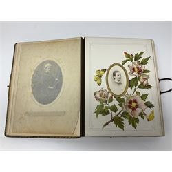  Victorian leather bound photo album, the interior leaves containing apertures of various sizes and shapes of portraits surrounded by printed floral designs, with brass clasp and painted gold decoration to edges, H30cm