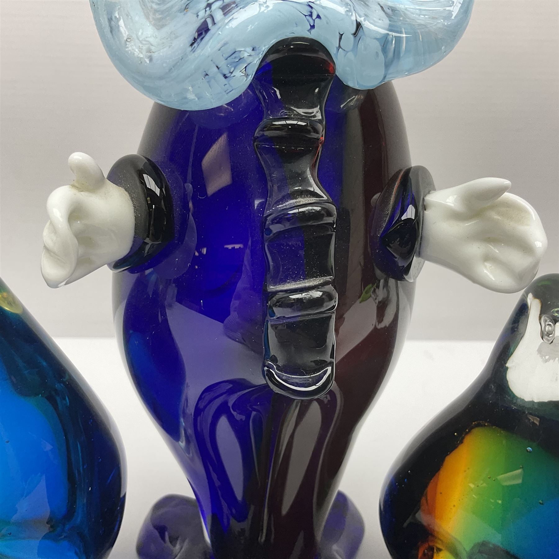 Murano glass clown, together with two glass penguin paperweights, clown H28cm
