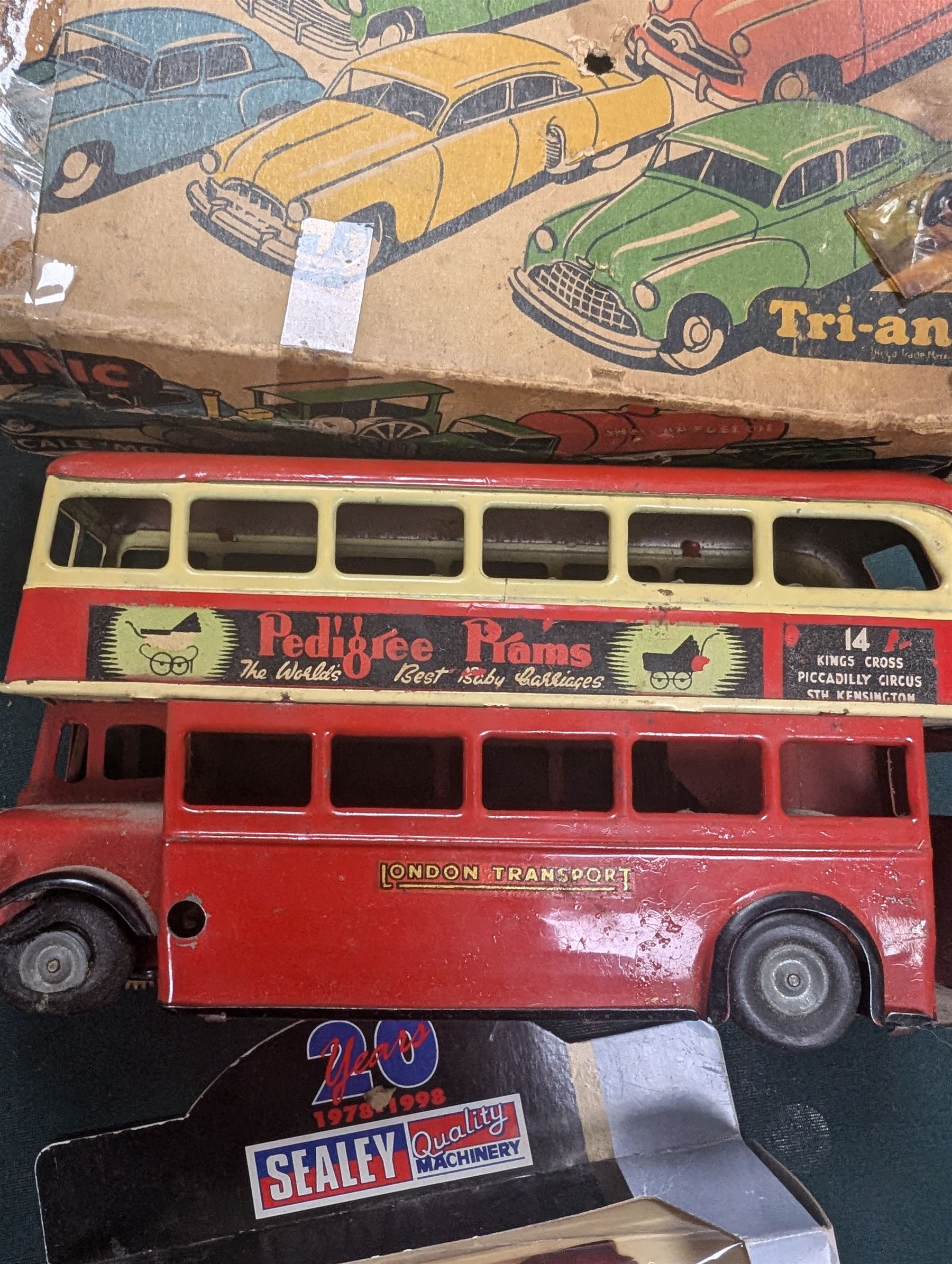 Small collection of model vehicles, including tin-plate trolley bus, Dinky Guy lorry, Triang Pedigree Prams bus, etc