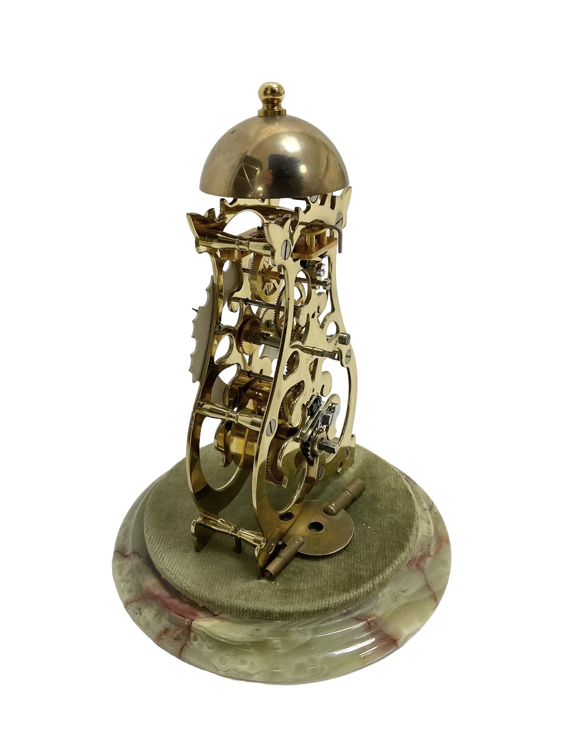 Thwaites & Reed - Small 20th century skeleton clock with a glass dome and stepped onyx base,  pierced movement frames with a silver chapter ring, Roman numerals, minute markers, and steel hands, domed brass bell with passing strike on the hour, with a lever platform escapement, wound and set from the rear. With key.