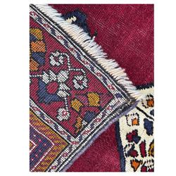 West Persian Hamadan rug, hand knotted, central medallion bordered by geometric and intricate floral motifs, displaying red cream and indigo colours with an orange coloured border  