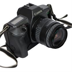 Three 35mm film SLR cameras, comprising Canon EOS 50E camera body with a Canon Ultrasonic EF 28-80mm 1:3.5-5.6 lens, together with a Canon EOS 600 camera body with a Sigma UC 28-70mm 1:3.5-4.5 lens and a Praktica MTL5 with a Carl Zeiss Jena DDR MC Flektogon 2.4/35 lens