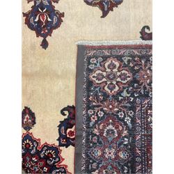 North East Persian Meshed carpet, the field with large central medallion decorated with stylised plant motifs, the field surrounded by panels, medallions and spandrels decorated with floral motifs, indigo ground border with overall floral design 