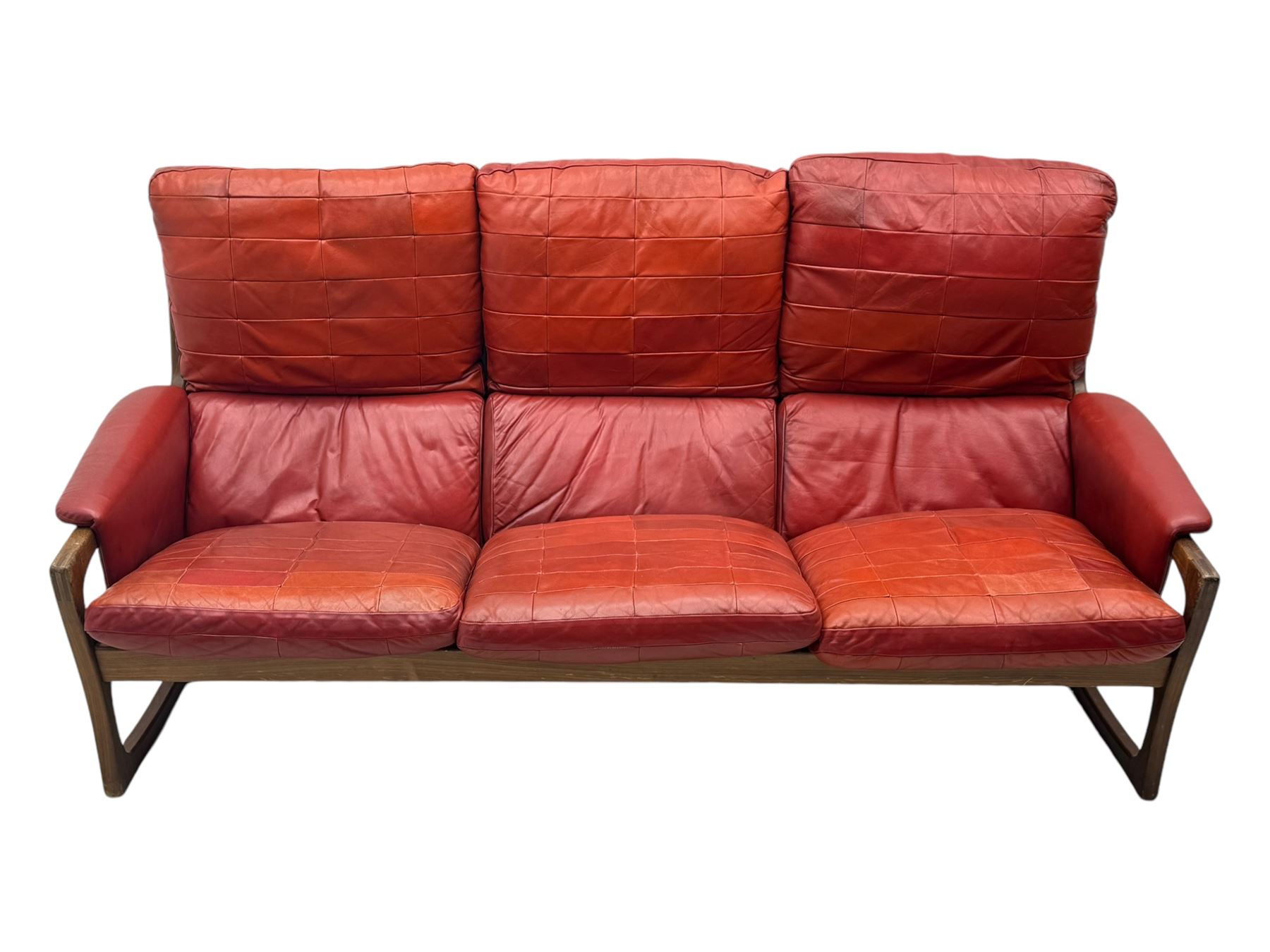 Folke Ohlsson for Gimson & Slater - mid-20th century Danish teak-framed sofa, red leather upholstery with patchwork design, raised on shaped teak side supports