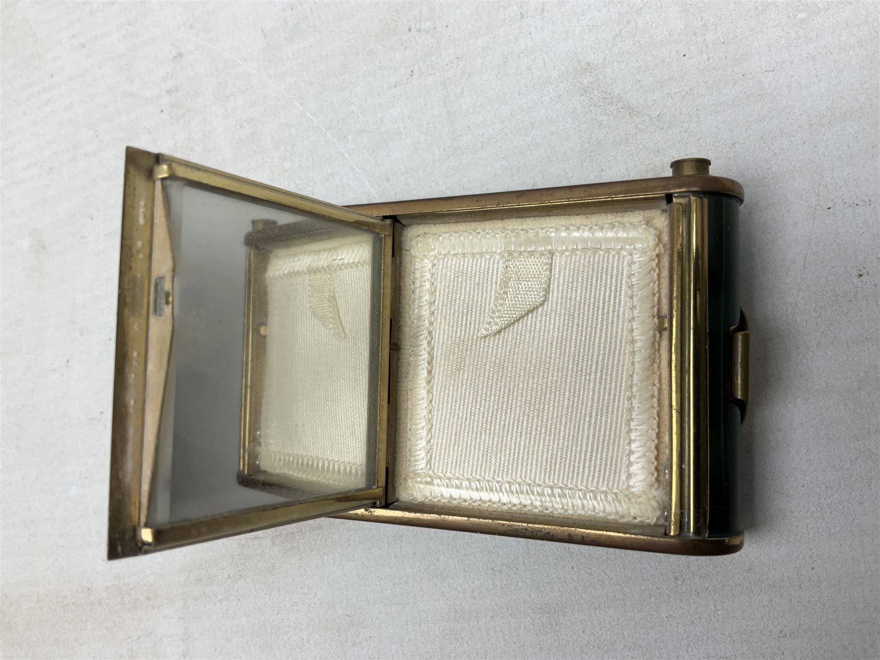 Art Deco camera shaped lady's musical compact and cigarette case, probably German, with green marble effect panels and gilt highlights, with large hinged opening to reveal engine turned brass interior with cigarette or lipstick holders, and the other side with musical mechanism and flip action powder compartment with mirror, L10cm
