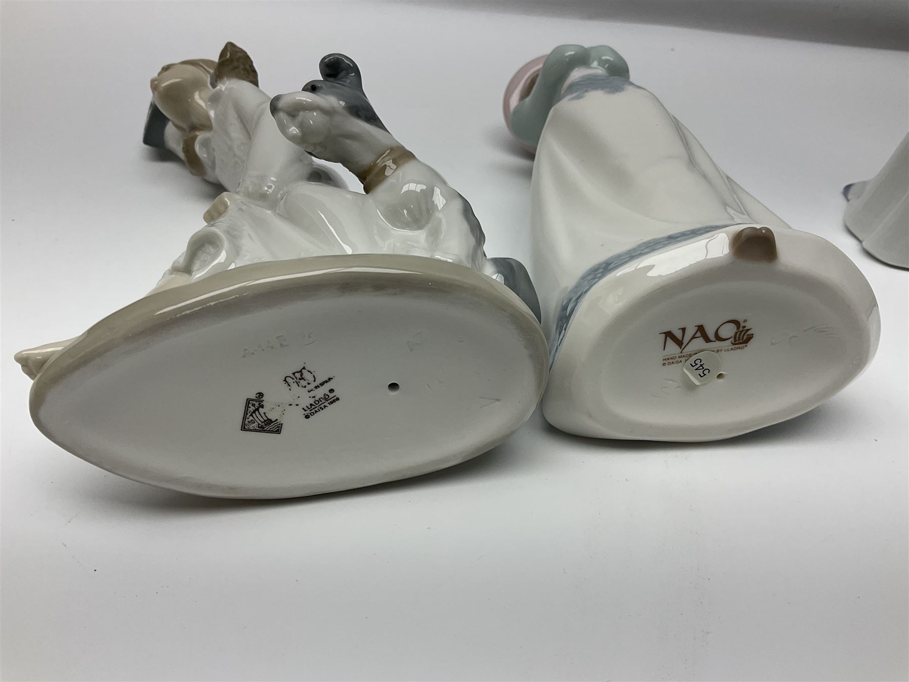 Eleven Nao figures to include Cowboy, Girl with Puppy, Clown, Girl in hat etc 