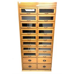 Haberdashery display cabinet with plaque ‘J.C. King Ltd, Shop fittings & Sundries, St John's Street London’, sixteen glazed front short drawers, above four deep drawers